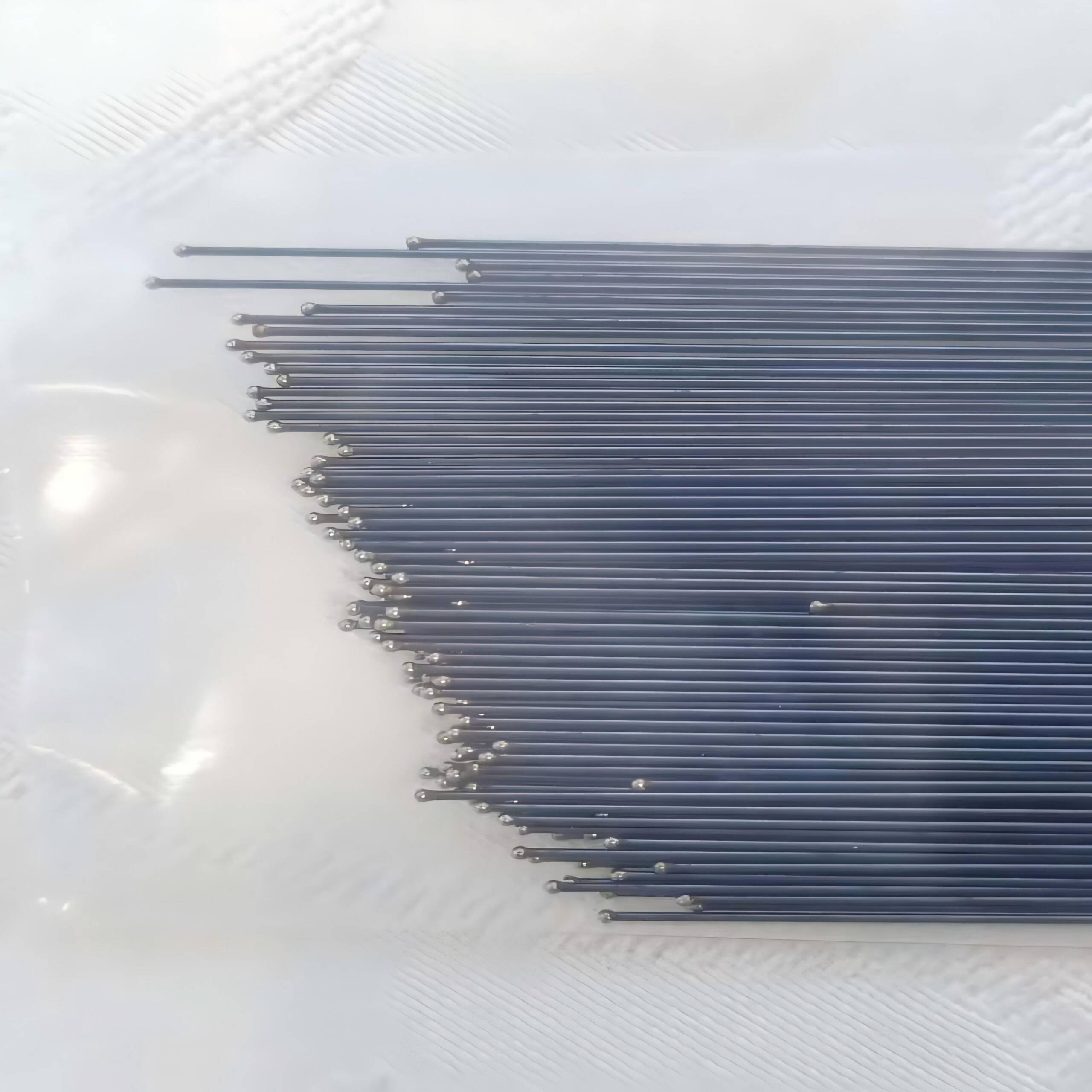 Close-up of nitinol mandrel and wire spool on factory table.