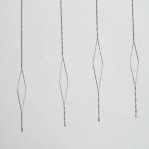 Close-up of superelastic nitinol cable for medical devices, showing flexibility and structure.