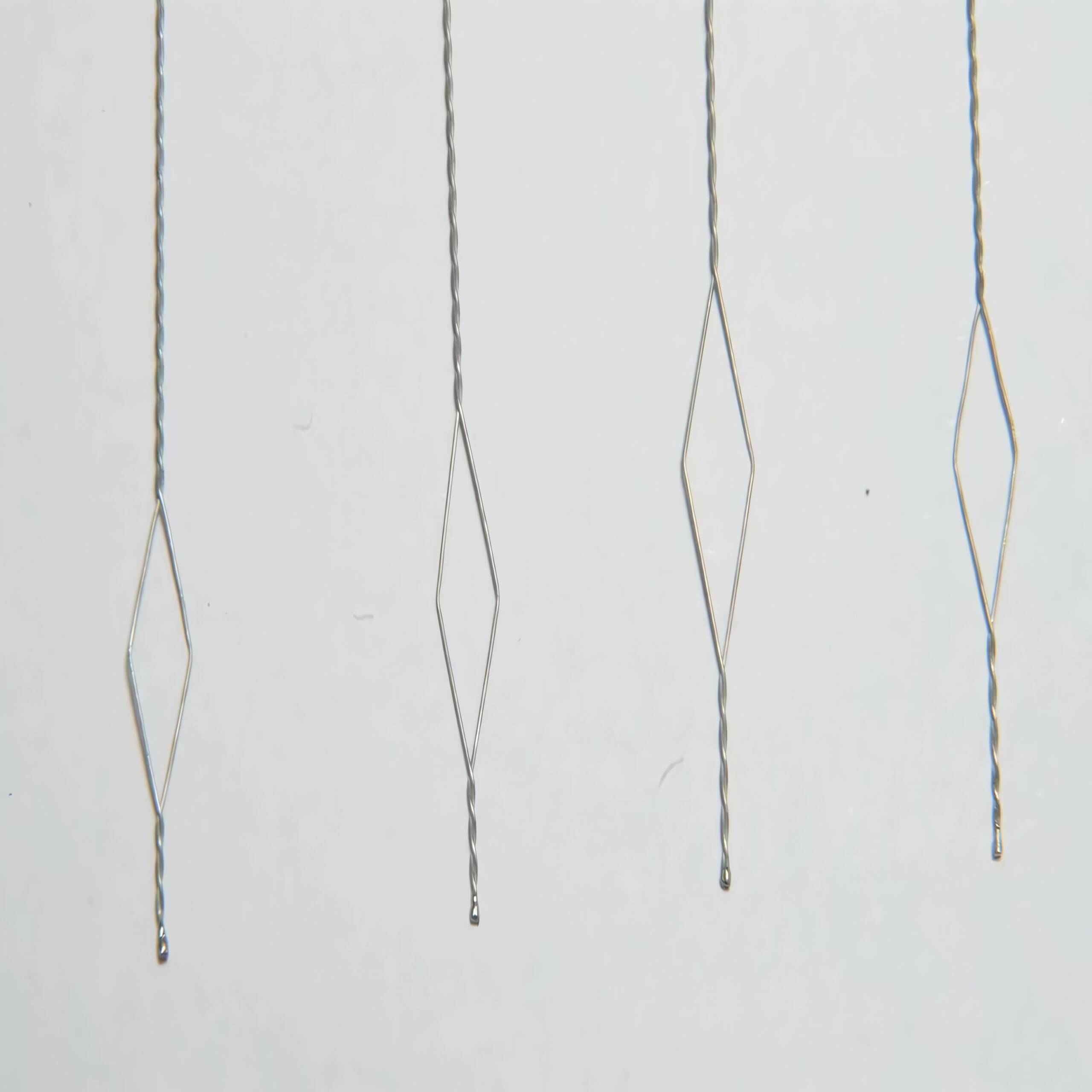 Close-up of superelastic nitinol cable for medical devices, showing flexibility and structure.